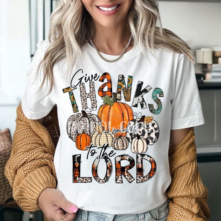 a woman wearing a t - shirt that says give thanks to the lord with pumpkins on it