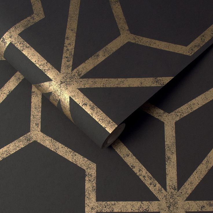 a black and gold patterned wallpaper with metallic foil on the bottom half of it