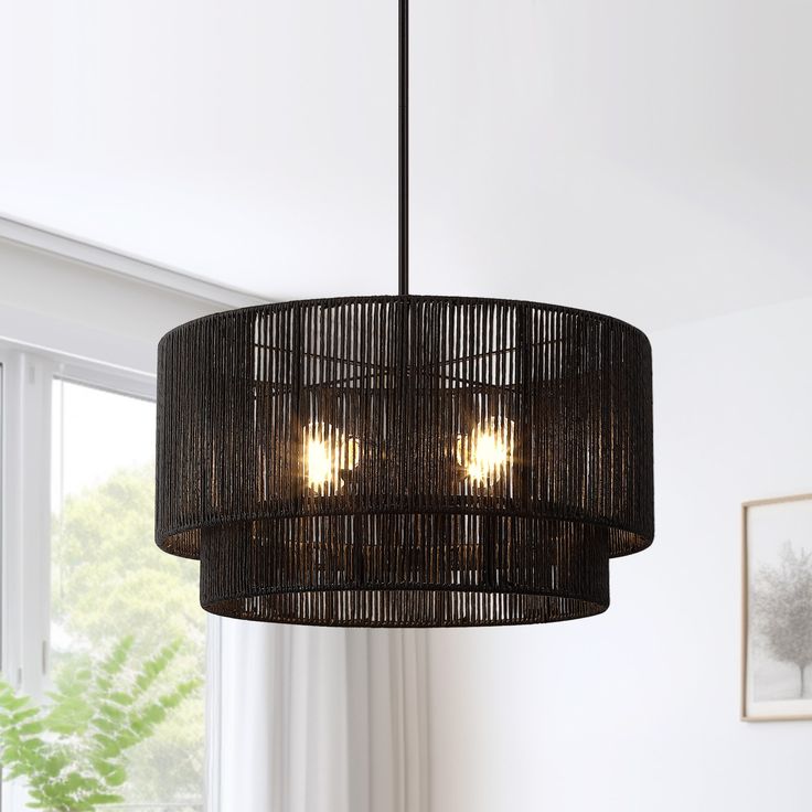 a black chandelier hanging from a ceiling in a room with white walls and windows