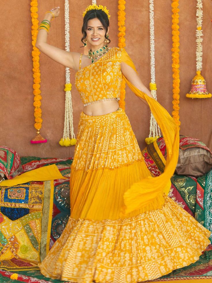 Enhance your beauty and make a statement with the Avantika Lehenga. This whimsical lehenga is designed to bring out your innate grace and grandeur. With its stunning mirror, pearl, stone, and embroidery work, this lehenga is perfect for women who want to shine at haldi ceremonies, special events, and festive occasions. Key Features: Color: Merigold Yellow Fabric & Work Style: Silk blouse with mirror, pearl, stone, and embroidery work Soft net lehenga with mirror, pearl, stone, and embroidery wor Haldi Ceremony Outfit For Bride Unique, Unique Haldi Outfits, Unique Haldi Outfits For Bride, Haldi Ceremony Outfit For Bride, Style Silk Blouse, Buy Lehenga Online, Bridal Lehenga Indian, Bridal Jewelry Indian, Indian Bridal Couture