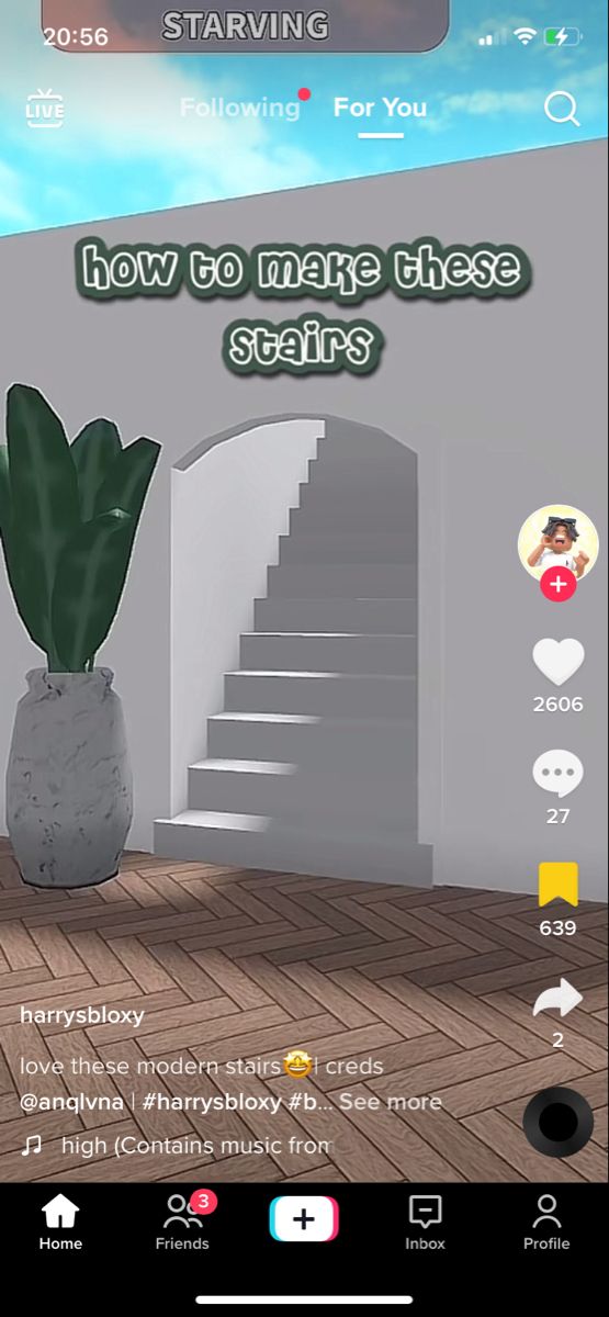 a screenshot of a house with stairs and a potted plant on the floor