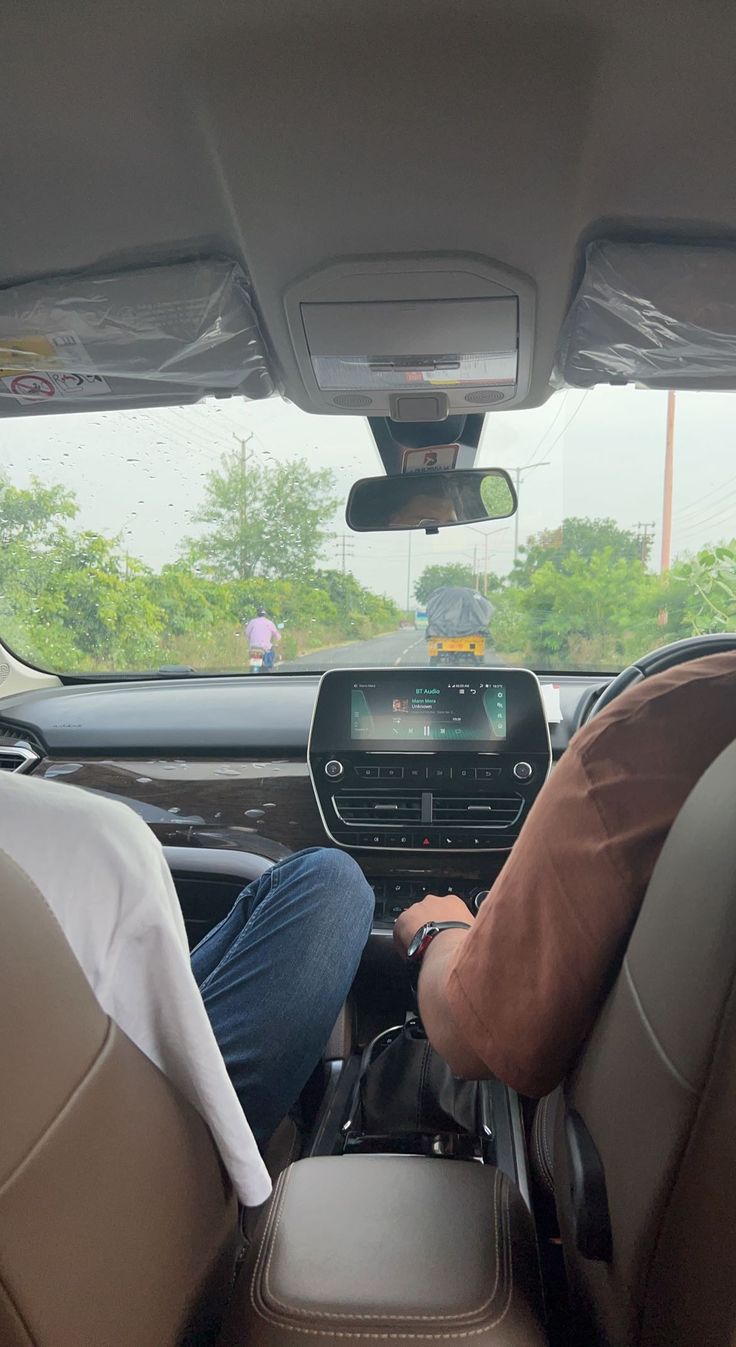 two people sitting in the driver's seat of a car