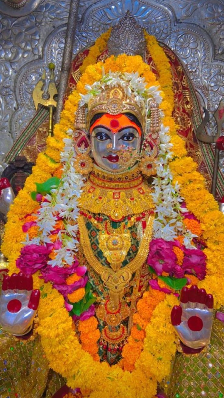 the idol is decorated with flowers and other things to be seen in this photo,