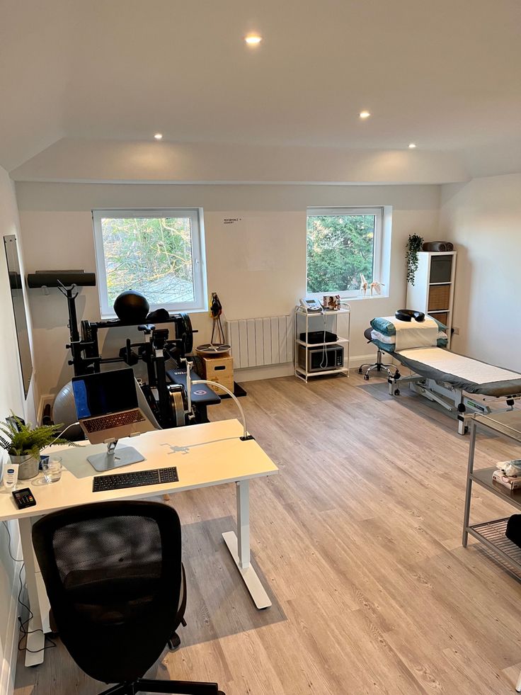 an office with desks, chairs and other items in the room that is empty