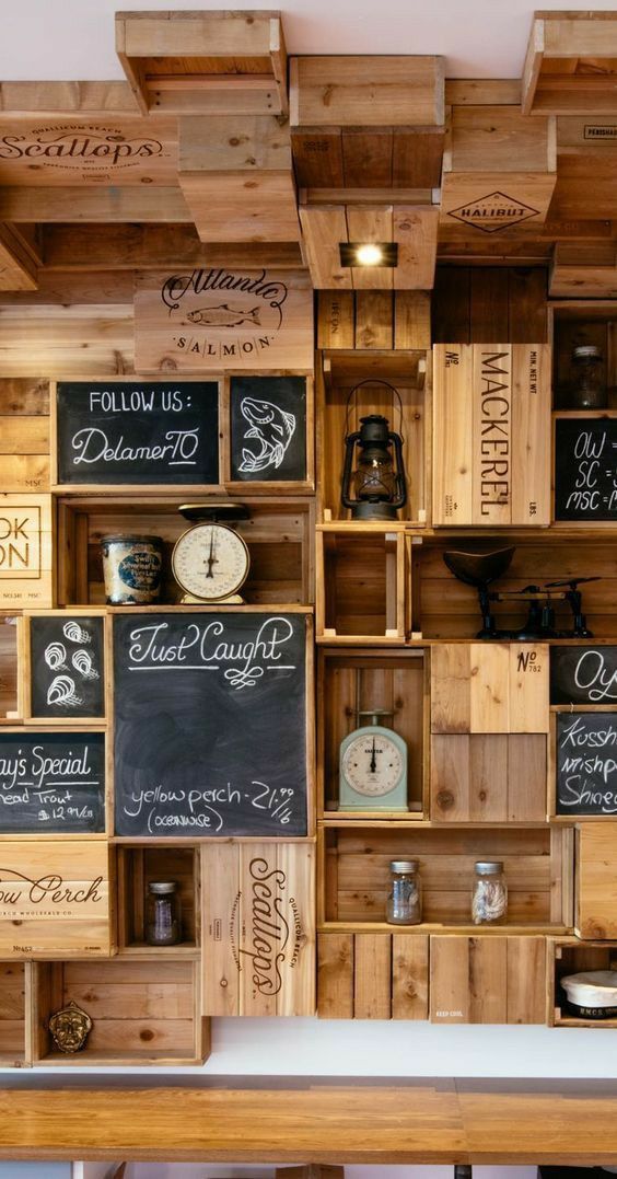 wooden shelves filled with different types of items and writing on the wall next to each other