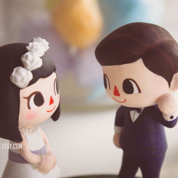 a bride and groom figurines on top of a cake