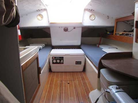 the inside of an airplane with wood flooring and white stove top oven in it