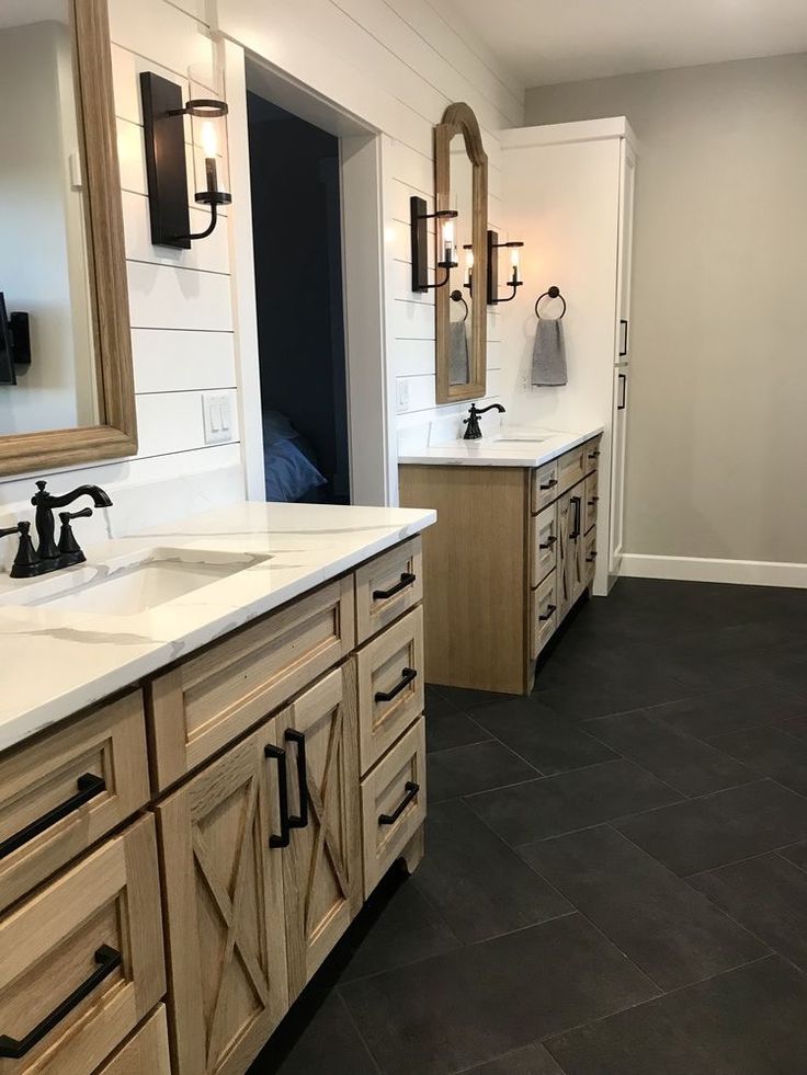 a large bathroom with two sinks and mirrors