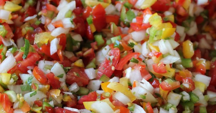 chopped up vegetables are mixed together in a bowl to make a colorful salad or side dish