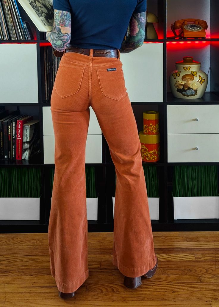 Groovy corduroy flares in a pumpkin rust orange! Features an ultra-flattering fit, high waist, slim fit through the thigh and major flare leg opening. Specially angled and shaped pockets in the back for a truly peachy looking butt. Approx. a 31.5" inseam. Features: Velvety soft, thin-wale corduroy flares Majorly babe'n high waist with an 11" rise Fitted through waist, hip, and thigh, with a true flare leg Button and zipper fly with belt loops Two flattering, tulip shaped pockets at back. Rust or 70s Academia, Corduroy Flares, 70s Chic, 70s Orange, Black Salt, 70s Vibes, 70s Inspired Fashion, Skirt Jumpsuit, Rust Orange