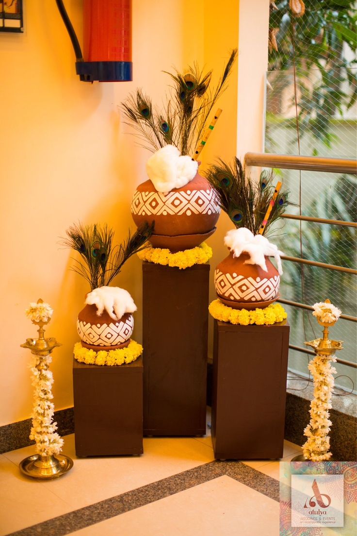 three vases with flowers and plants in them sitting on the floor next to each other