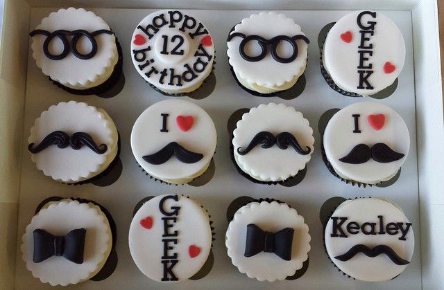 twelve cupcakes decorated with mustaches and glasses