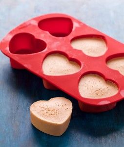 an ice tray with heart shaped cookies in it