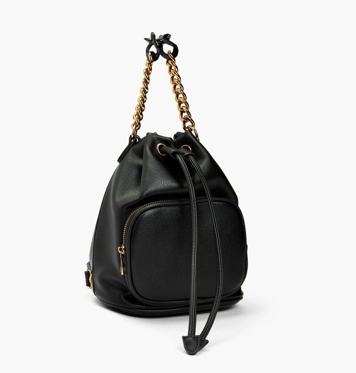 A handbag that meshes functional with endless wearing options. Composed of smooth vegan leather and gold hardware detailing. Drawstring opening as well as front zipper pocket for extra compartment space. Equipped with a multi tone chain link top handle as well. Highlight is its detachable shoulder straps that can be attached to any of the four rings to wear as a shoulder bag, sling pack, backpack, crossbody, etc. Functional, fun, and forever accomodating for an everyday bag. Composition: Vegan L On-the-go Bucket Bags With Gold-tone Hardware, Travel Bucket Bag With Gold-tone Hardware, Travel Bucket Shoulder Bag With Metal Hardware, Chic Bags With Chain Strap And Double Handle, Travel Bucket Bag With Metal Hardware And Top Handle, Chic Travel Bag With Metal Hardware, Versatile Bucket Bag With Gold-tone Hardware, Versatile Bucket Tote Bag With Gold-tone Hardware, On-the-go Top Handle Bucket Bag With Gold-tone Hardware