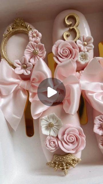 pink shoes with flowers and gold accents in a box