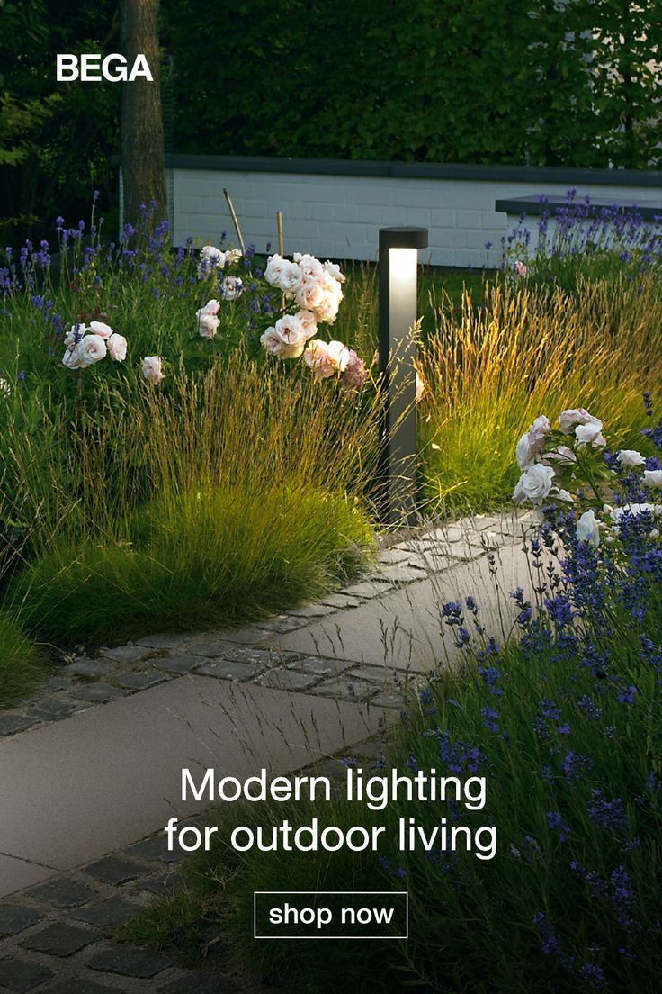 Stone pathway is lit by garden bollards and decorated with tall shrubs and purple and white flowers. Modern Pathway, Small Front Porch Ideas Entrance, Outdoor Living Design, Pathway Lighting, Greenhouse Gardening, Home Landscaping, Outdoor Decor Backyard, Yard Design, Garden Landscape Design