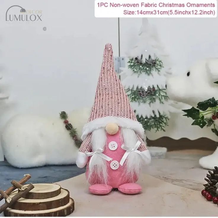 there is a pink and white gnome figurine next to other christmas decorations on the table