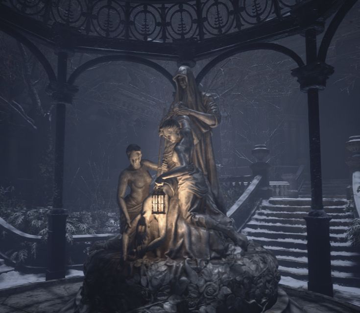 a statue in the middle of a courtyard with stairs leading up to it and two people standing next to it