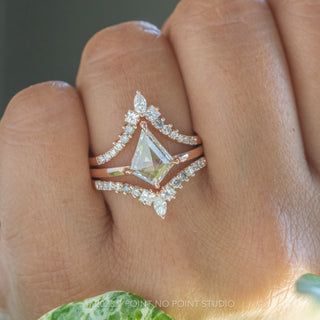 a woman's hand with a diamond ring on it