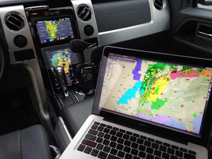 an open laptop computer sitting on top of a car dashboard next to a gps map