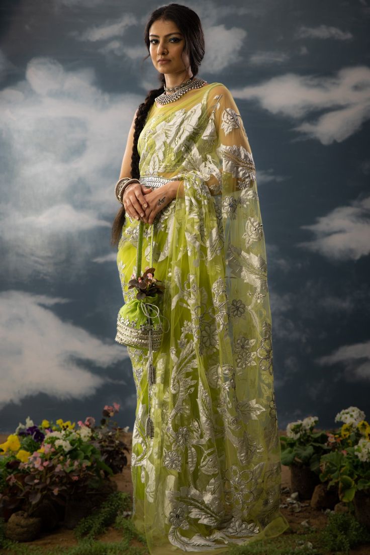 Editor's Note A green patchwork sari in sheer net fabric, it is fully adorned with floral jaal patchwork, aari work and zardozi. The sari comes with a green embroidered blouse handcrafted in chanderi, cotton zari with patchwork and metallic silver. Note: Potli and belt is for styling purposes. Color: Green Fabric: Glass nylon Component: Sari and blouse Occasion: Haldi mehndi and Wedding Guest Care: Dry Clean Only About the Designer Saksham & Neharicka make modernising Indian wear with rich handw Nature Mythology, Blouse Yoke, Fabric Glass, Saree For Women, Hand Woven Textiles, Net Fabric, Aari Work, Popular Culture, Embroidered Blouse