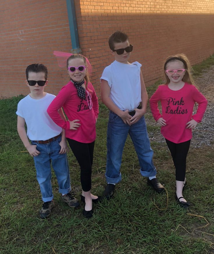 three children wearing pink ladies shirts and sunglasses