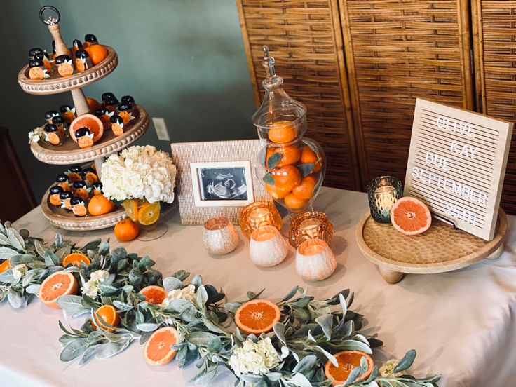 a table topped with oranges and other decorations