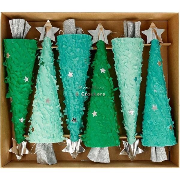 a box filled with green frosted christmas trees next to silver foil stars and tinsel