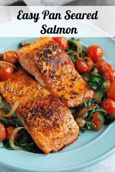 salmon and spinach on a blue plate with the words easy pan seared salmon