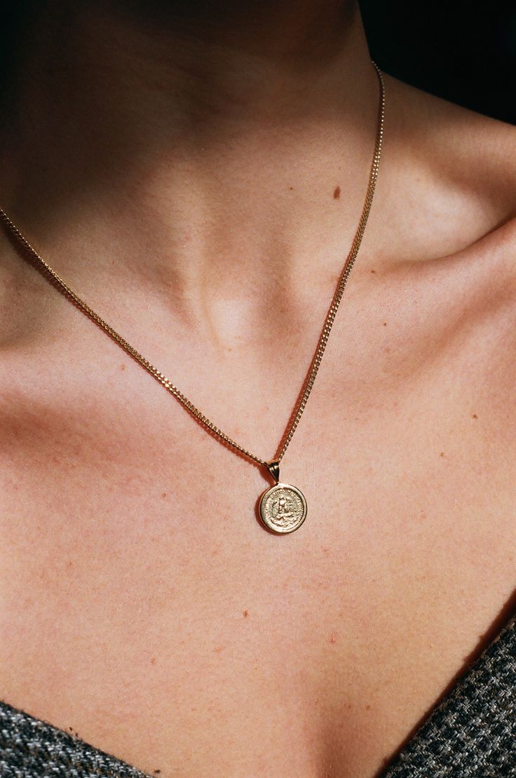 Inspired from a vintage piece, this sweet, simple necklace looks lovely by itself or layered with other favorites. The coin pendant is cast in brass and 14k gold plated. The front side features an imprint of an eagle perched on a branch with an arch of micro script reading, "Estados Unidos Mexicanos". The back is a smooth blank finish. The pendant comes on a 2 mm gold plated curb chain with a circle clasp closure. We are excited to share energy from this sale and donate a portion of the profit f Vintage Pendant Jewelry For Everyday, Everyday Etched Round Pendant Necklaces, Vintage Brass Coin Necklace, Tarnish Resistant, Vintage Brass Medallion Necklace Tarnish Resistant, Vintage Brass Coin Necklace Tarnish Resistant, Everyday Etched Round Pendant Necklace, Vintage Tarnish Resistant Medallion Necklace, Minimalist Etched Round Pendant Necklace, Classic Necklace With Coin Pendant