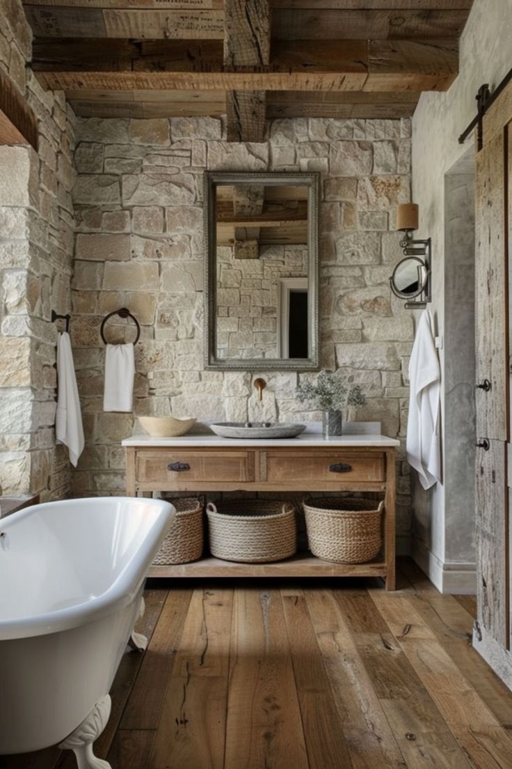 an old fashioned bathroom with stone walls and wood flooring is shown in this image