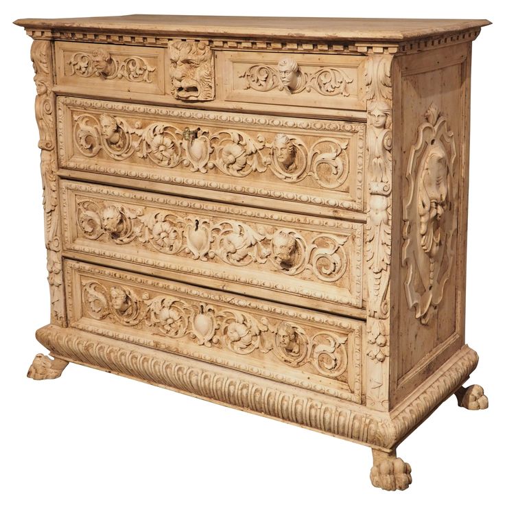 an antique chest of drawers with carvings on it