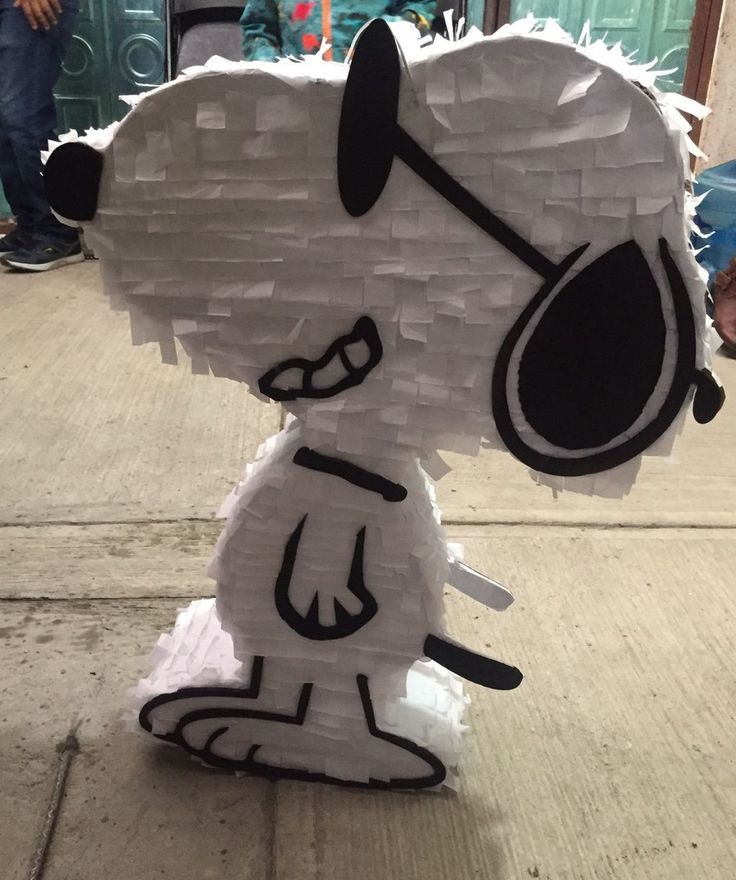 a paper sculpture of a dog on the sidewalk