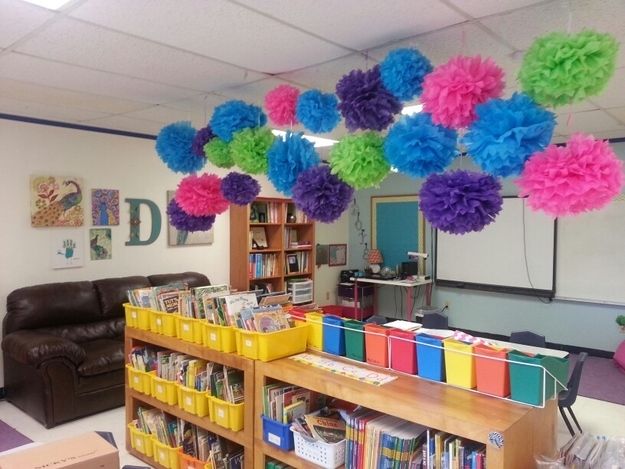 the library is decorated with tissue pom poms