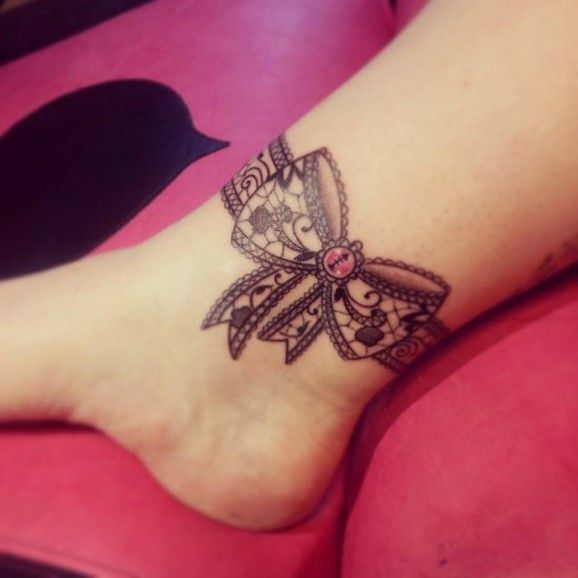 a woman's foot with a butterfly tattoo on it