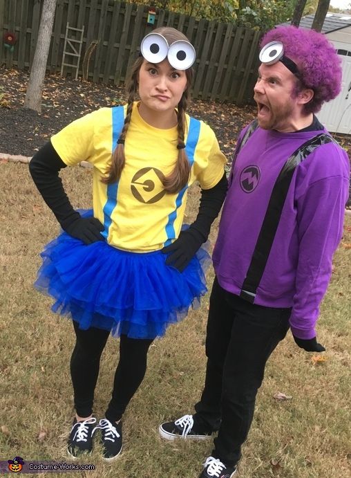 two people dressed up in costumes standing next to each other on the grass with their hands on their hipss