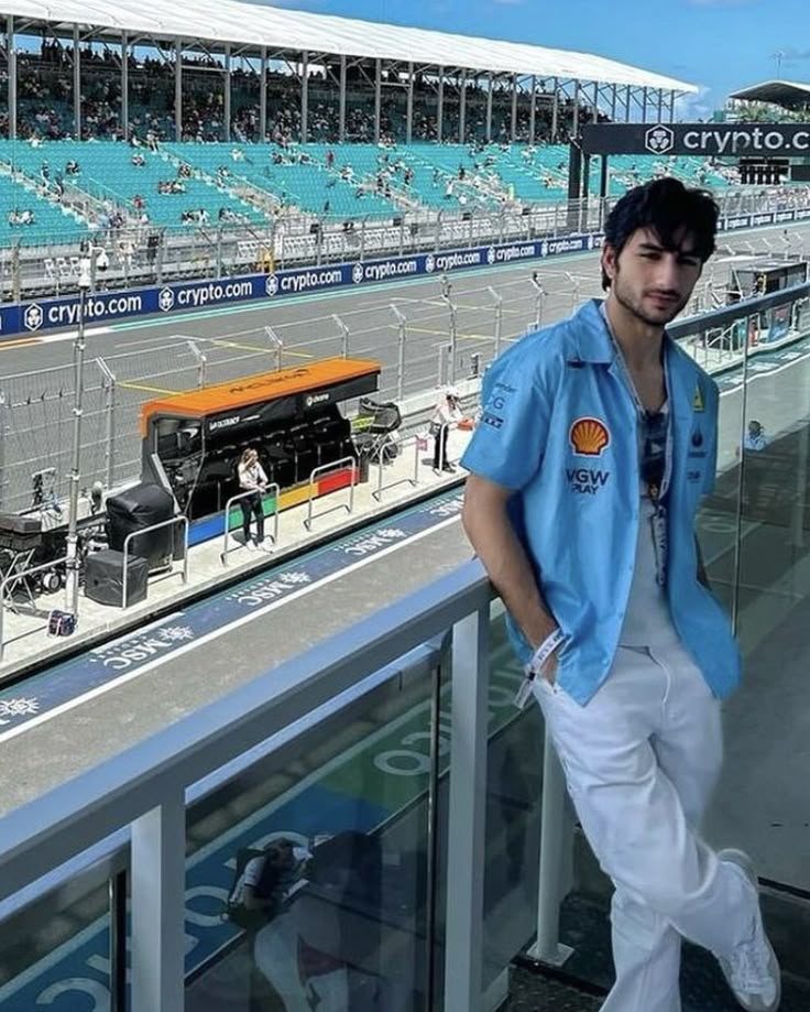 a man standing in front of an empty stadium