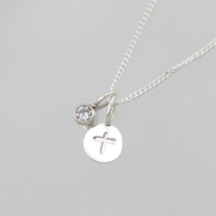 "Handcrafted sterling silver necklace with a stamped cross. Comes on your choice of a 16 or 18 inch sterling silver chain with the artist's tag attached at the clasp. (Shown on a 16\" chain) Makes an excellent gift. Can be worn a number of ways. Add more some birthstone drops for a more personal touch! To add a birthstone drop pendant, go to: https://www.etsy.com/listing/127617405/birthstone-drop-pendant-sterling-silver?ga_search_query=birthstone+drop+pendant&ref=shop_items_search_3" Inspirational Sterling Silver Nickel-free Charm Necklaces, Inspirational Sterling Silver Nickel-free Charm Necklace, Cross Necklace With Charms As Gift, Sterling Silver Cross Pendant Necklace With Charms, Sterling Silver Necklaces With Cross Pendant Charms, Dainty Sterling Silver Cross Pendant Charm Necklace, Spiritual Sterling Silver Hand Stamped Necklaces, Sterling Silver Charm Necklace With Cross Pendant, Sterling Silver Cross Charm Necklace