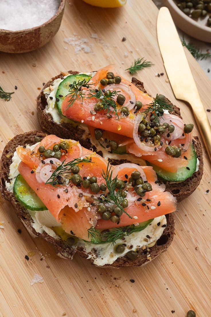 two slices of bread topped with salmon and capers