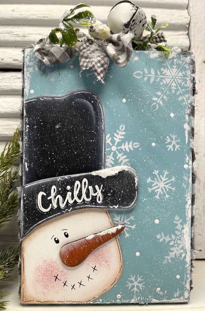 a wooden sign with a snowman on it