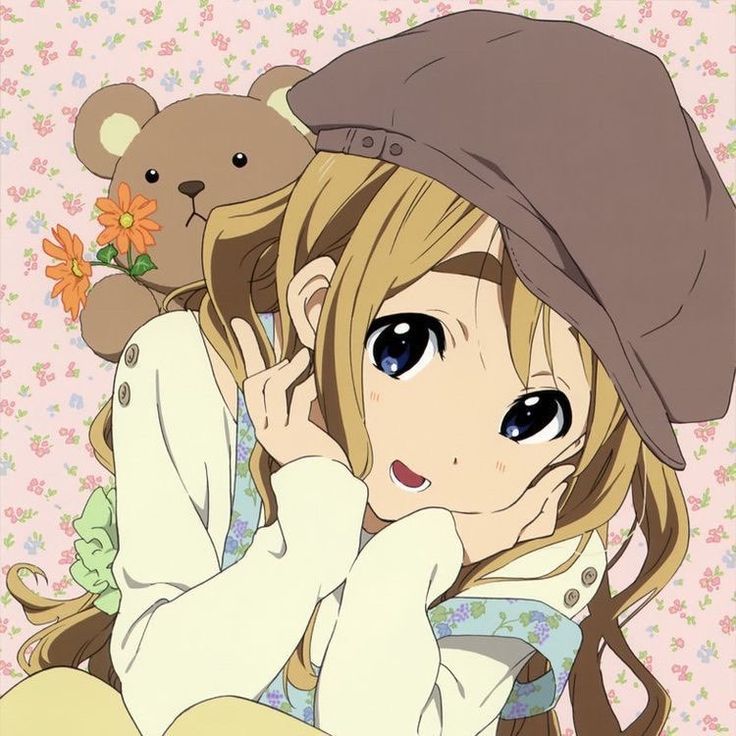 a girl with long hair and a hat holding a teddy bear in front of her face