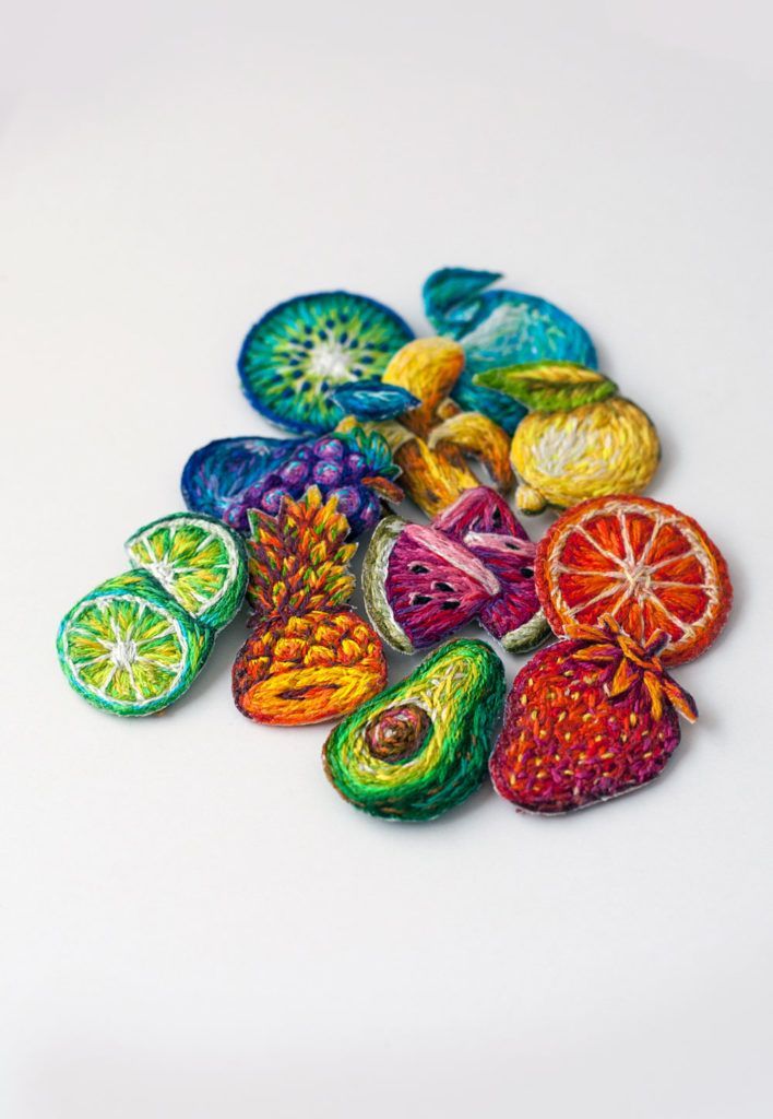 a pile of colorful fruit slices sitting on top of a white table