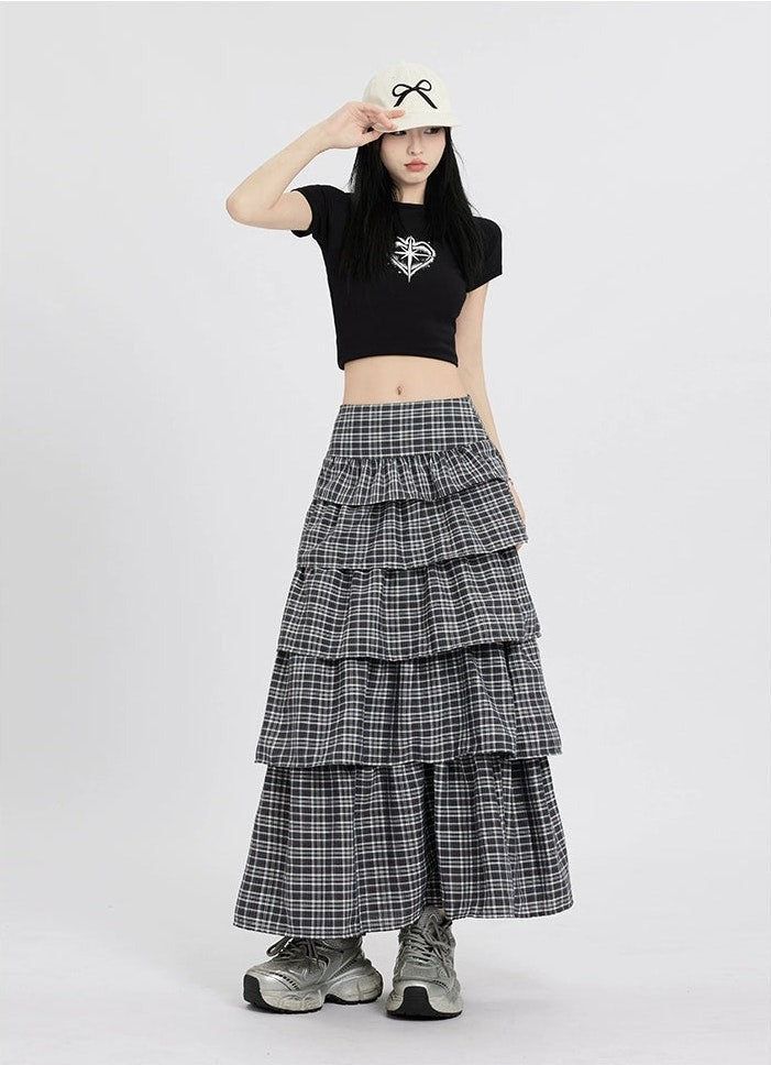 Channel understated chic with this Layered Plaid Maxi Skirt featuring delicate ruffle details.
Crafted from a comfortable blend of mainly cotton, this skirt showcases a multi-layered design that adds a playful twist to the classic plaid pattern. The high-waist cut ensures a flattering silhouette, while the versatile style makes it easy to dress up or down. It's a piece that carries a perfect balance of edgy and professional aesthetics.
Pair this skirt with a tucked-in graphic tee and sneakers fo Casual Tiered Pleated Maxi Skirt, Layered Long Skirt For Spring, Chic Cotton Ruffled Mini Skirt, Relaxed Cotton Mini Skirt With Ruffles, Cotton Ruffled Mini Skirt With Relaxed Fit, Cotton Tiered Mini Skirt With Lining, Chic Layered Tiered Bottoms, Chic Layered Tiered Skirt Bottoms, Chic Cotton Tiered Mini Skirt