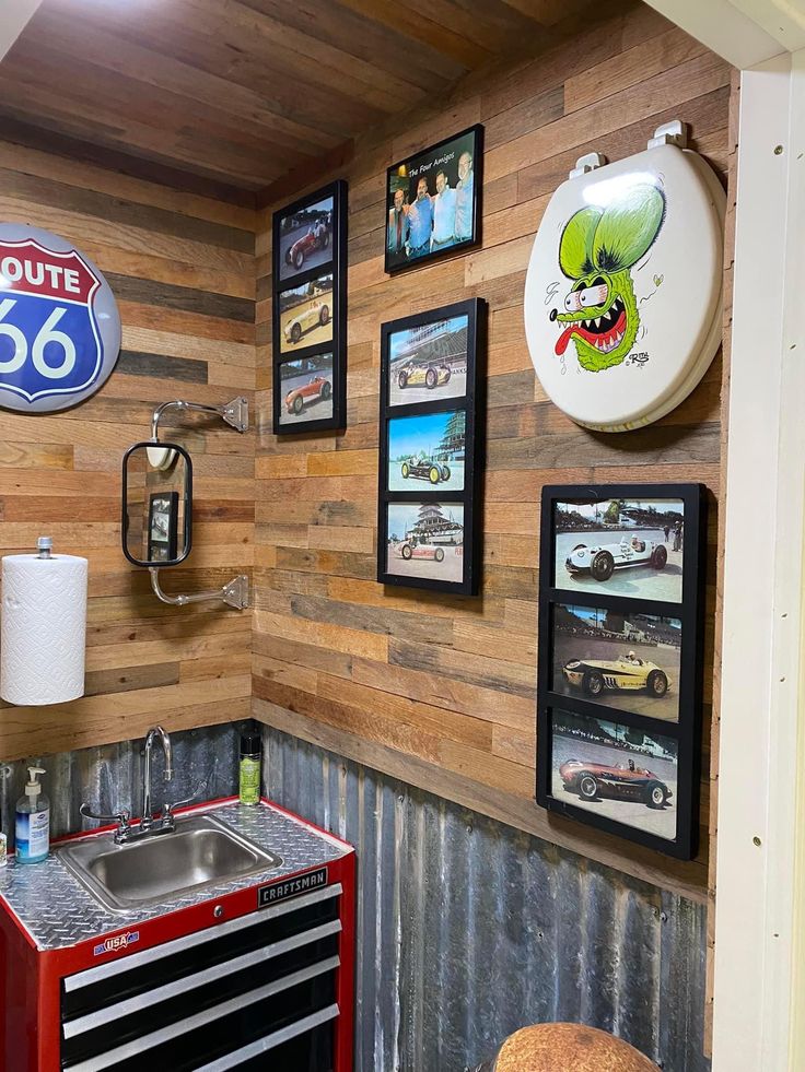 there are many pictures on the wall above the sink in this kitchen, including an old gas pump