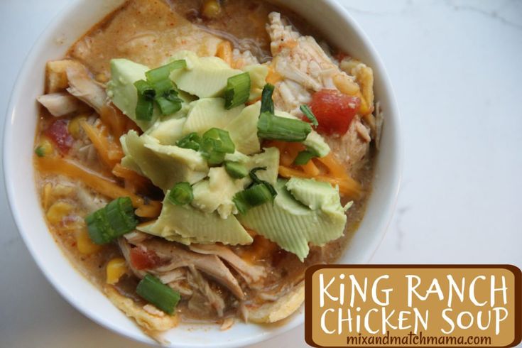 a bowl of chicken soup with avocado, tomatoes and other toppings on top