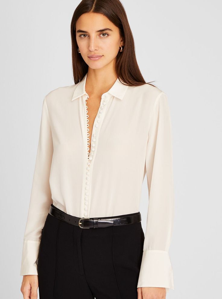 Detail oriented. Split cuffs and self-covered buttons add style to the luxe silk crêpe de Chine Helek shirt. The perfect top to dress up your off-hours denim. Luxury Collared Tops For Work, Elegant Business Blouse With Placket, Chic Semi-formal Button-up Shirt, Chic Business Tops With Concealed Placket, Chic Tops With Concealed Placket For Business, Elegant Tailored Shirt For Work, Elegant Workwear Blouse With Placket, Elegant Workwear Blouse, Chic Semi-formal Shirt With Buttons