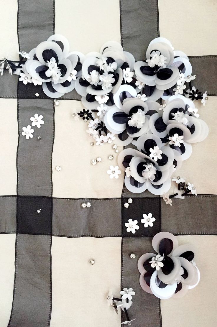 some white and black flowers on a checkered table cloth