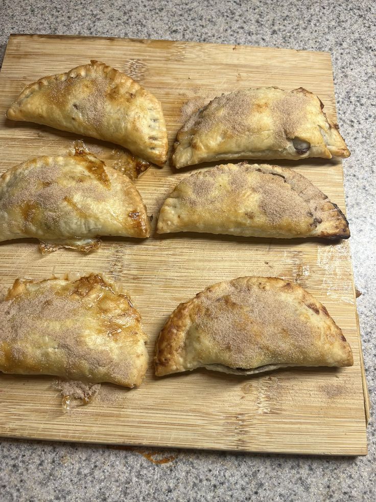 four pastries on a cutting board ready to be eaten