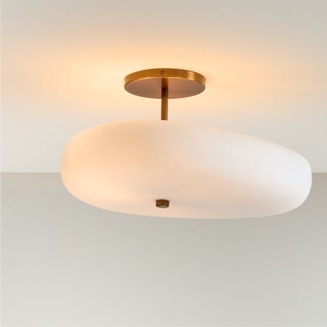 a white ceiling light with a gold ring on the bottom and an oval glass shade