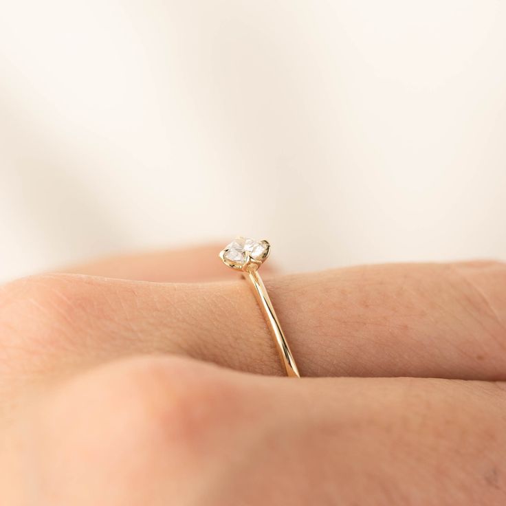 0.25ct brilliant cut diamond, 4mm, near colorless, eye clean 0.50ct GIA certified Excellent cut grade G color SI1 clarity (Made to order) Band width: approx. 1.1mm to 1.4mm tapered band High profile four prongs flower setting Made of 100% recycled solid 14k yellow gold and ethically sourced gemstone Alice ring is minimal and dainty, features 0.25ct brilliant cut diamond in our signature flower setting. The tapered band adds elegance to this unique engagement ring. The diamond size and quality ca Minimalist Moissanite Diamond Cut Rings, Minimalist Moissanite Wedding Ring, Delicate Brilliant Cut Diamond Ring, Minimalist Emerald Cut Diamond Ring With Single Cut Diamonds, Delicate 14k Gold Stackable Rings Brilliant Cut, Minimalist Single Cut Diamond Wedding Ring For Anniversary, Minimalist Single Cut Diamond Wedding Ring, Minimalist 14k Gold Diamond Ring In Diamond White, Minimalist 14k Gold Diamond White Diamond Ring